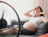 photo of a pregnant woman on the couch